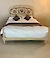 A king size polychrome and parcel gilt bed